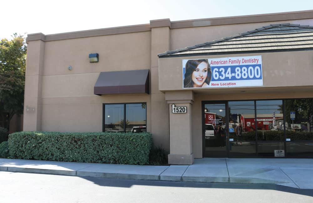 A dental office building with a prominent sign indicating its purpose.