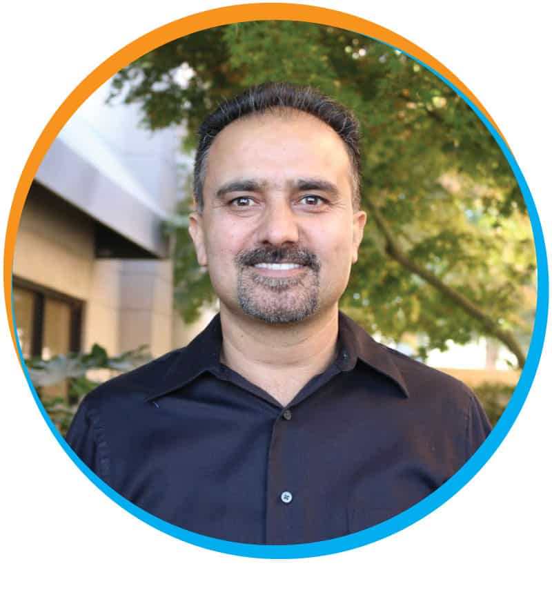 Dr. Surjit Chahal, DDS, wearing a black shirt, showcasing professionalism and approachability.